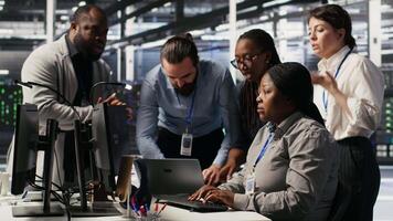 Angry technicians in server room fighting each other after encountering critical error popup during maintenance. Engineers having tense conversation, doing system recovery brainstorming chat, camera A video