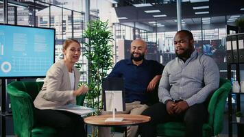 Group of professionals using remote communication tools for business meeting, focusing on strategy planning and investment discussions. Diverse organizational environment. Camera A. video