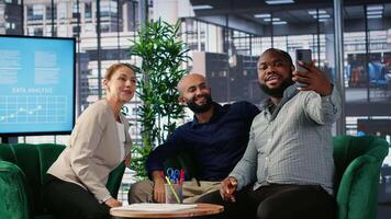 Powerful people celebrate their deal with a photo on media platforms, finishing the meeting and reaching a verbal agreement for the collaboration. Diverse leaders ensure success story. Camera B. video
