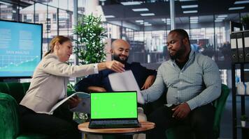 CEO and executive team conducting research next to green screen in a corporate environment, developing strategy and sharing expertise to drive company investment and performance. Camera A. video