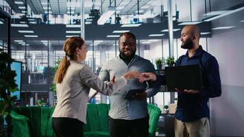 Business professionals shaking hands and reaching an agreement after the meeting, exchanging a handshake and giving their consent. CEOs making an alliance for global growth. Camera A. video