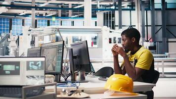 African american technician evaluates renewable energy metrics at pc station, using advanced monitoring and manufacturing tools. Engineer improves solar power system accuracy. Camera B. video