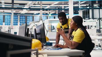 Black engineering team working at a high tech solar panel factory, reducing downtime and finetuning to a seamless production process. Technicians optimizing solar energy manufacturing. Camera B. video