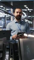 Vertical Happy data center engineering team members collaborating on neural network software development. Smiling server hub coworkers implementing machine learning technology in workplace, camera A video