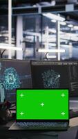 Vertical Isolated screen laptop and computer in data center overseeing server infrastructure powering artificial intelligence workflows. Mockup notebook used for monitoring equipment configurations video