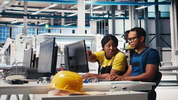 Factory workers team check solar energy system diagnostics on PC, using analytical tools and CAD software. Technicians detecting faults and finetuning automation for renewable energy. Camera B. video