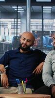 Vertical Corporate professionals discussing global market trends in boardroom, sharing expertise and performance metrics. Building a success story through planning and strong leadership skills. Camera B. video