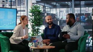 Multicultural business leaders sharing expertise and developing a strategy through collaboration and partnership in a corporate environment. CEOs networking in office space. Camera B. video