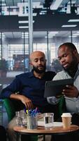 Vertical Group of empowered company leaders discuss corporate performance metrics, driven by vision and global investment strategy. International diverse business partners in conference. Camera A. video