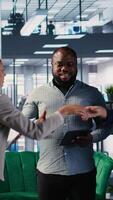 Vertical Business professionals shaking hands and reaching an agreement after the meeting, exchanging a handshake and giving their consent. CEOs making an alliance for global growth. Camera A. video