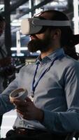 Vertical Admin using VR headset in data center to update server tech, configuring equipment using software tools. Server farm employee reviewing hardware analytics using virtual reality, camera A video