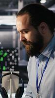 Vertical Employee requesting help from manager to fix hacked equipment systems. Stressed data center admin reacting to spyware popup on computer screen, launching emergency response protocol, camera A video
