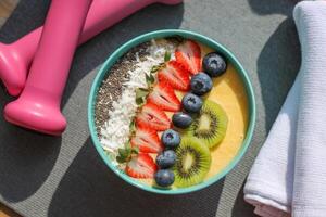 Fresh smoothie bowl topped with vibrant fruits and chia seeds, perfect for a health-conscious morning routine photo