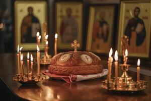 Traditional Orthodox bread centerpiece surrounded by candles and icons during a solemn religious ceremony at dusk photo