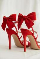 Strappy red high heels with stylish bows perfect for glamorous occasions photo