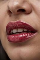 Glossy deep red lips glistening under soft light, capturing vibrant beauty and allure in the moment photo