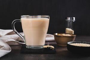 Tahini latte with sesame spread in a cup on the table photo
