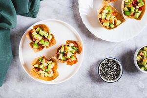 Appetizing cups of guacamole in pita bread on a plate on the table top view photo