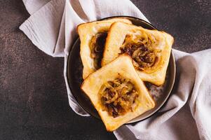 Close up of upside down tarts with caramelized onions on a plate on a table top view photo