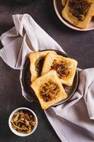 Homemade caramelized onion upside down pies on a plate on a table top and vertical view photo