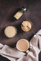 Coffee with sesame paste tahini in a cup on the table top and vertical view photo