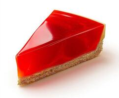 Slice of glossy red cake with biscuit base on white background. photo