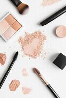 Makeup and brushes on white background creating stylish display photo