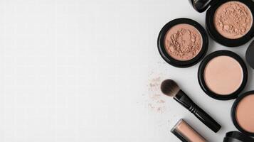 Makeup products and brushes on white background photo