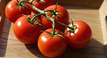 Tomato on Vine on Wood Tray photo