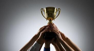 Gold Trophy Being Held Up by Hands photo