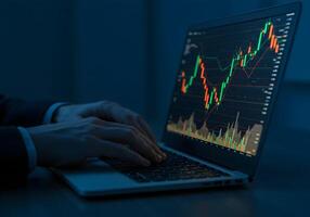 Person Analyzing Stock Market Chart on Laptop photo