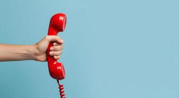 Red Telephone Handset on Blue Background photo