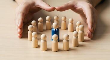 Wooden Figures and Hand Protection on Table photo
