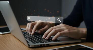 Hands Typing on Laptop with Search Bar Overlay photo