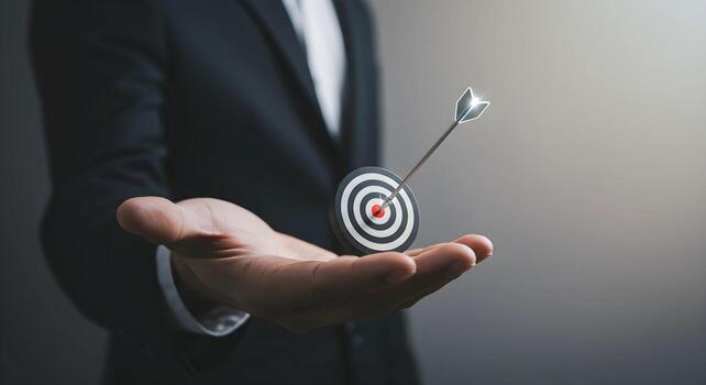 Target with Arrow in Hand of Man in Suit photo