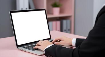 Person Typing on Laptop with Blank Screen photo