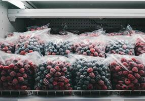 Frozen Berries in Plastic Bags on Shelf photo