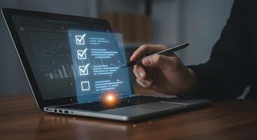 Online Checklist on Laptop Screen with Pen photo