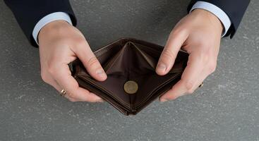 Empty Wallet with Coin Held by Hands photo