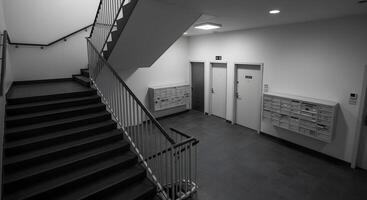 Apartment Staircase with Mailboxes and Doors photo