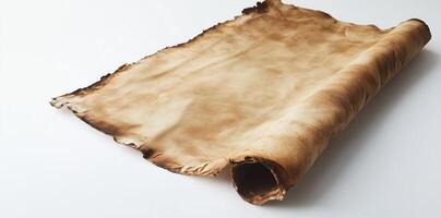 Aged parchment scroll with burnt edges and vintage texture isolated on white background, history and ancient manuscripts concept photo