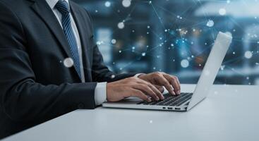 Businessman typing on laptop with abstract network connecting technology photo