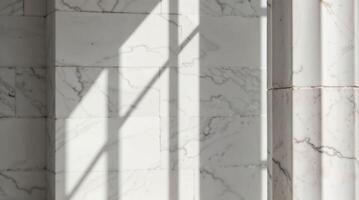 Sunlight creates dramatic shadows on textured marble wall and column photo