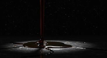 Syrup Pouring Dark Surface Abstract photo