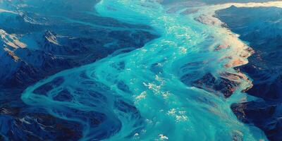 Stunning aerial view of a winding glacial river flowing through rocky mountains at sunset photo