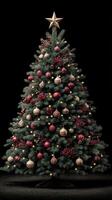 Elegant Christmas tree adorned with red and gold ornaments, glowing lights, and a star topper for a festive atmosphere photo