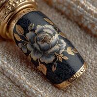 Intricate black and gold floral design on a decorative object with fine detailing photo