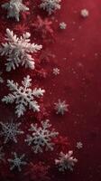Snowflakes gently fall on a rich red background, creating a festive winter atmosphere during the holiday season photo