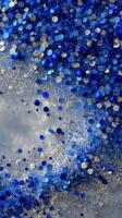 Vibrant blue and silver glitter cascading in an artistic display photo
