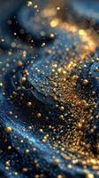 Shimmering golden particles dance on deep blue fabric under soft light at an artistic display photo